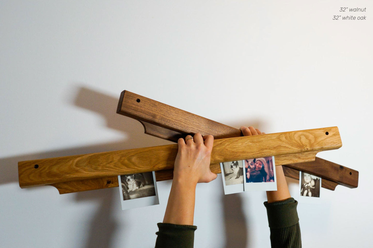  The Gravity Bar, by Biglow Woodcraft; a wooden support for papers, photographs and images. Two wooden bars with photographs in the hands of a woman. Hardwood Walnut and White oak