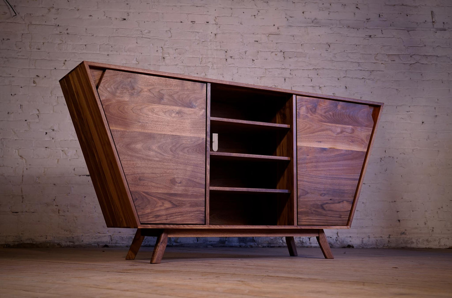 A custom entertainment unit standing tall against a historic brick wall in Winnipeg's historic exchange district.