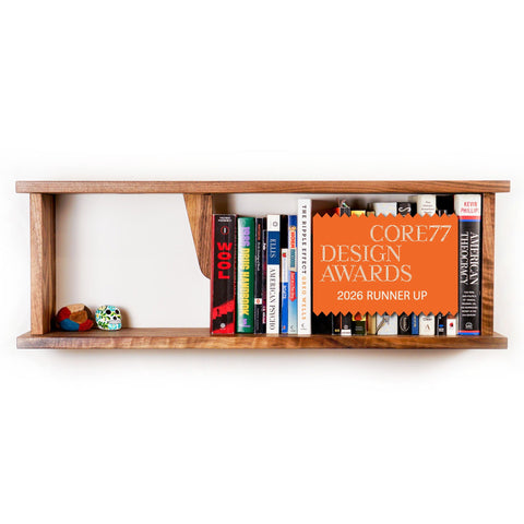 Book Stop assembled and mounted on wall holding a row of books - Biglow Woodcraft - Walnut