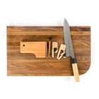Gravity Bar wall mounted paper holder cut into slices on walnut chopping block cutting board to show mechanism Biglow Woodcraft 