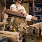 Gravity Bar wall mounted paper holder held by Canadian who made it - Biglow Woodcraft - Walnut
