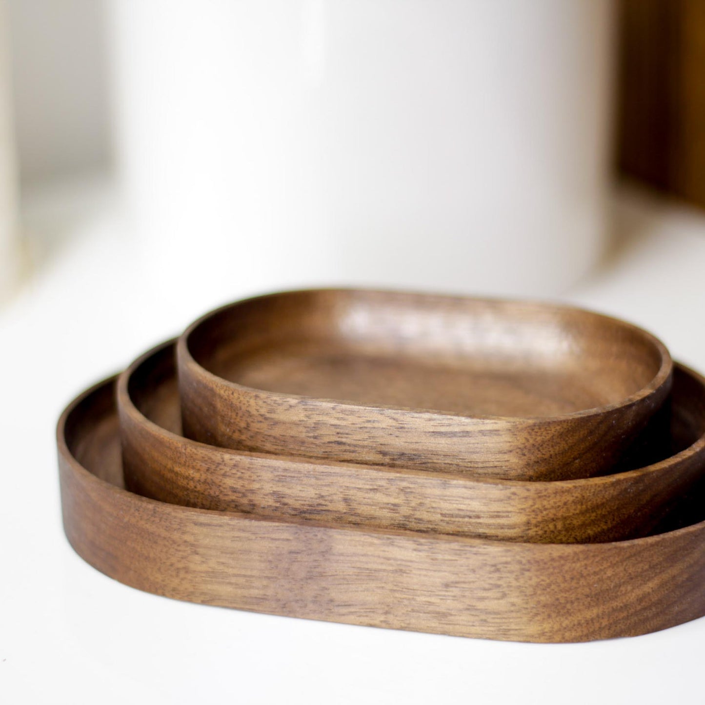 The Thing Spots, by Biglow Woodcraft; a wooden tray set for small objects. A set of Thing spots on a white table. Hardwood Walnut