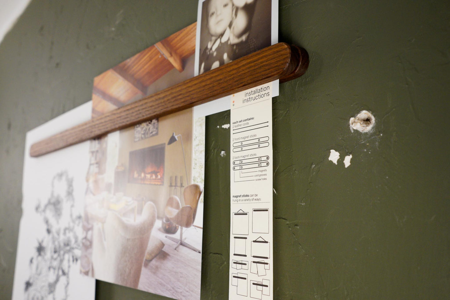  The Magnet Sticks, by Biglow Woodcraft; a wooden support for papers, photographs and images. A set of magnet sticks with photographs installed on a green wall. Hardwood Roasted ash